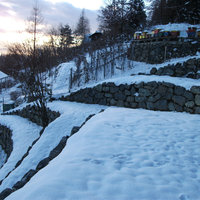 zu Mauern geschlichtete, schneebedeckte Steine
